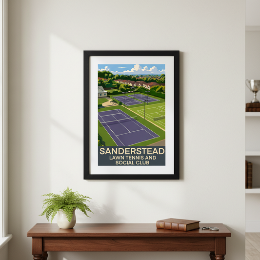 Framed artwork of Sanderstead lawn tennis and social club on a wall above a wooden table.