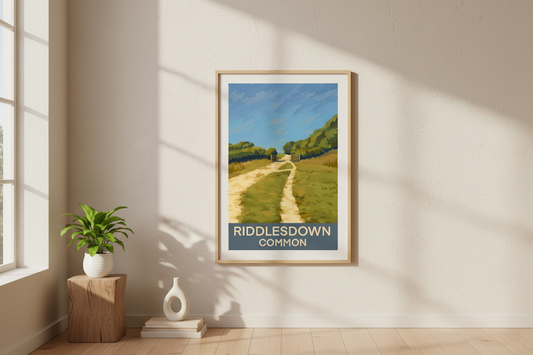 Framed art print retro travel poster of Riddlesdown Common Kenley Croydon Surrey on a wall in a bright room with sunlight.